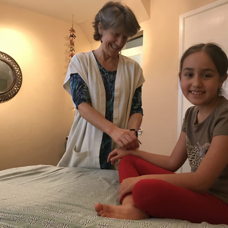 child receiving acupuncture treatment